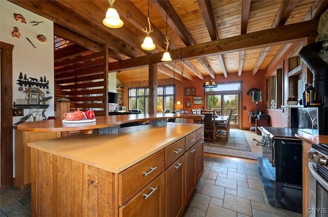 463 Hughes Rd, Russia, NY 13438 - kitchen featuring stone tile floors, wooden ceiling, beam ceiling, stainless steel gas range, and pendant lighting