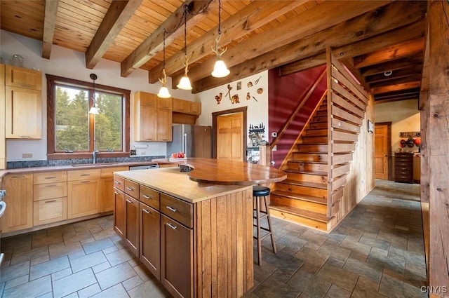 463 Hughes Rd, Russia, NY 13438 - kitchen featuring wood ceiling, stone tile flooring, beam ceiling, a kitchen breakfast bar, and a center island