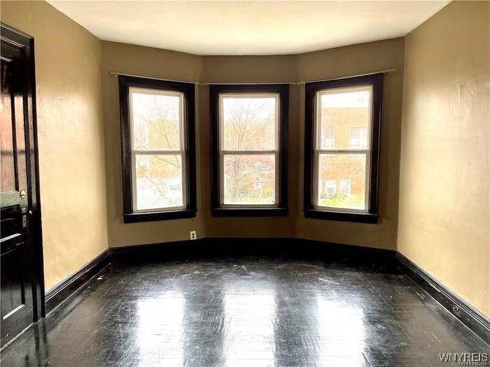 69 Red Jacket Pkwy, Buffalo, NY 14220 - spare room featuring healthy amount of natural light, baseboards, and wood finished floors
