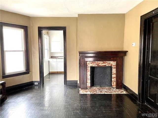69 Red Jacket Pkwy, Buffalo, NY 14220 - unfurnished living room featuring a brick fireplace and baseboards