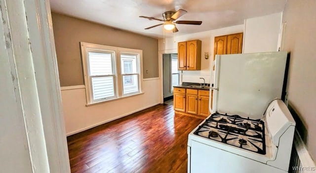 11 Indian Church Rd Unit S, Buffalo, NY 14210 - kitchen with white appliances, ceiling fan, dark wood finished floors, brown cabinetry, and dark countertops