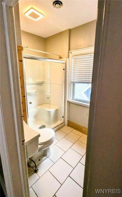 11 Indian Church Rd Unit S, Buffalo, NY 14210 - full bathroom featuring a stall shower, toilet, tile patterned flooring, and baseboards