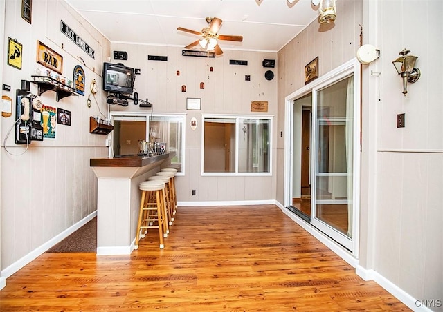 6 Tyler Ct, Manlius, NY 13104 - kitchen with wood finished floors, a ceiling fan, baseboards, and a kitchen bar