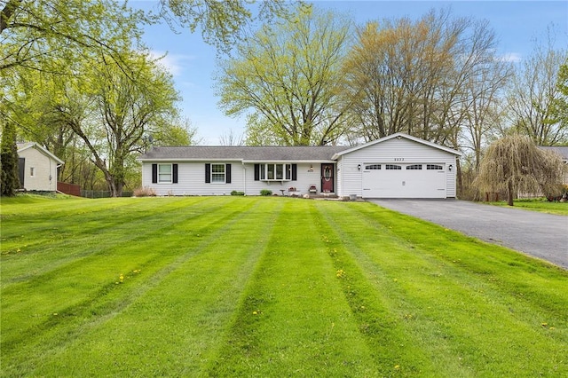 2033 Clarkson Parma Tl Rd, Clarkson, NY 14420 - ranch-style home with a garage, driveway, and a front yard