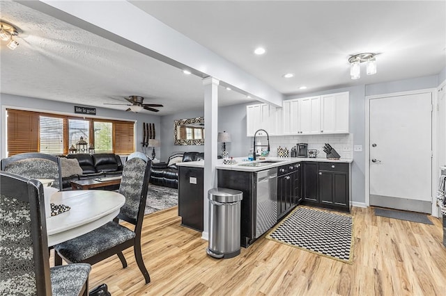 2033 Clarkson Parma Tl Rd, Clarkson, NY 14420 - kitchen featuring a sink, light countertops, light wood-type flooring, white cabinetry, and a ceiling fan