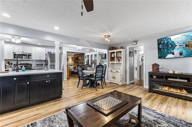 2033 Clarkson Parma Tl Rd, Clarkson, NY 14420 - living room with a textured ceiling, light wood-style flooring, a ceiling fan, recessed lighting, and baseboards