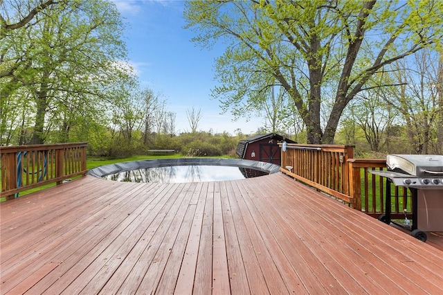 2033 Clarkson Parma Tl Rd, Clarkson, NY 14420 - deck with a grill, a storage shed, and an outbuilding
