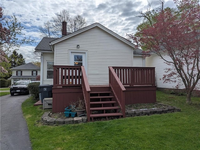 5 S Hartland St, Royalton, NY 14105 - back of property featuring a yard, a wooden deck, a chimney, and stairs