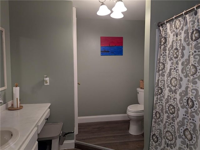 5 S Hartland St, Royalton, NY 14105 - bathroom with toilet, wood finished floors, a chandelier, vanity, and baseboards