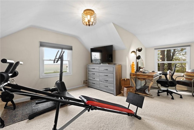 exercise room with vaulted ceiling, healthy amount of natural light, baseboards, and carpet