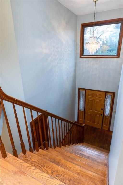 48 Hemlock Ln, Erwin, NY 14870 - stairway featuring a chandelier and wood finished floors
