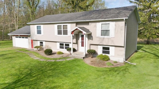 split foyer home featuring a front lawn, roof with shingles, and a garage