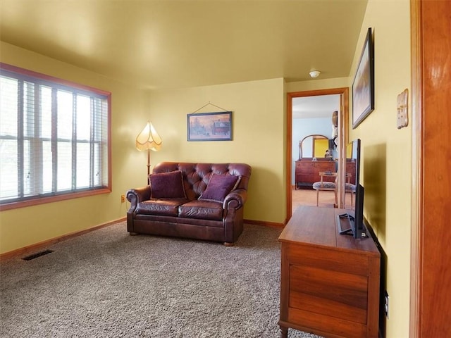 living room featuring carpet flooring and baseboards