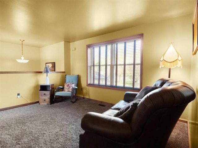 living room featuring carpet floors and baseboards