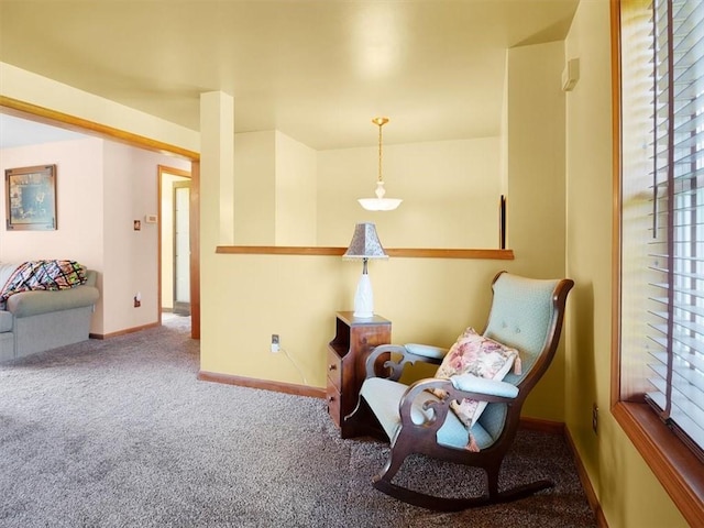 sitting room featuring carpet and baseboards