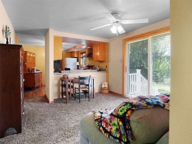 bedroom with multiple windows, freestanding refrigerator, and carpet