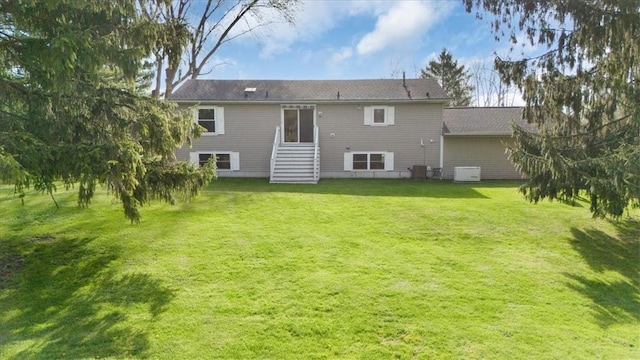 rear view of house featuring a lawn