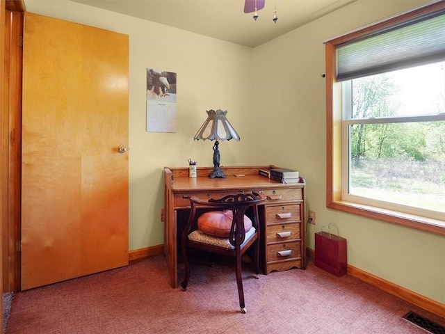 office space featuring light carpet and baseboards