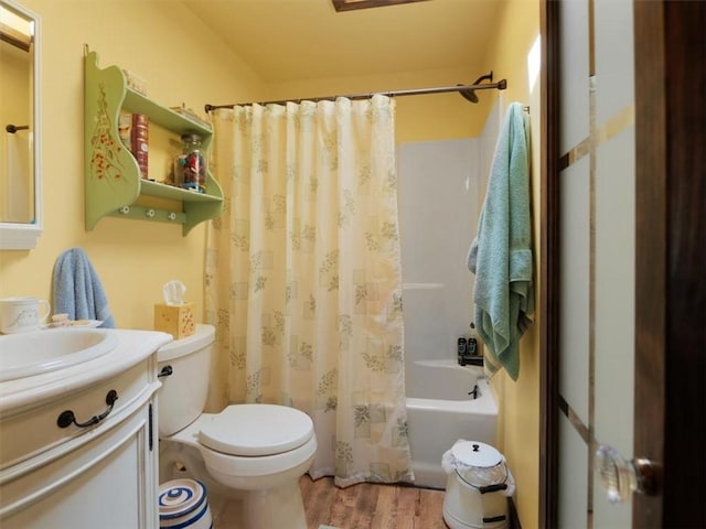 full bathroom featuring wood finished floors, toilet, vanity, and shower / bath combo with shower curtain