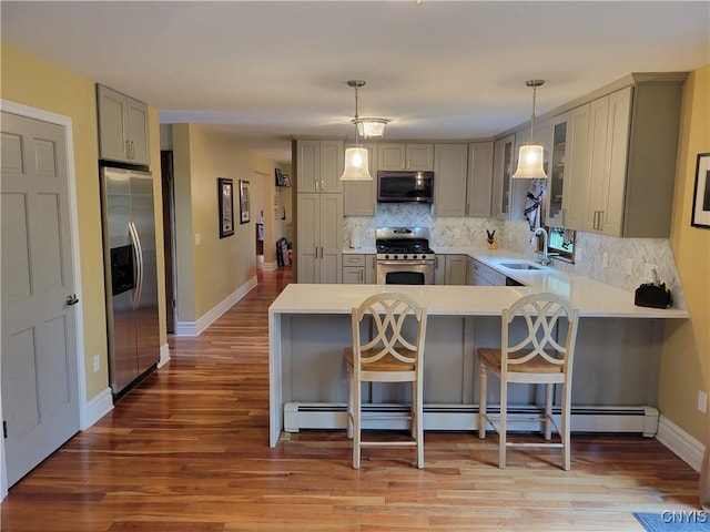 3130 Meadow View Ln, Sennett, NY 13021 - kitchen with stainless steel appliances, gray cabinetry, a sink, backsplash, and a peninsula