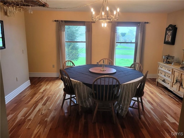 3130 Meadow View Ln, Sennett, NY 13021 - dining space featuring wood finished floors, plenty of natural light, a chandelier, and baseboards