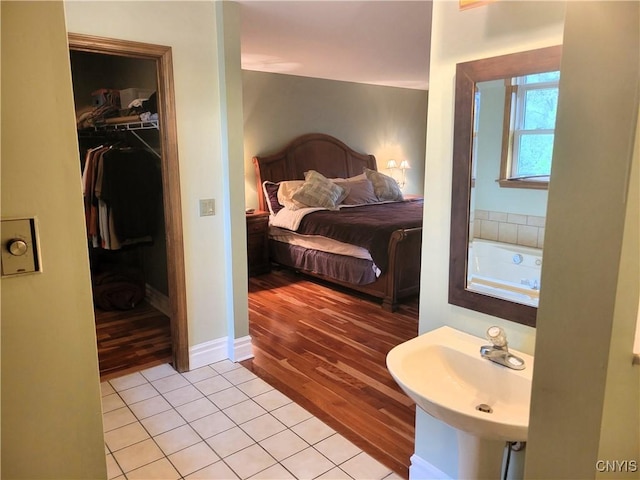3130 Meadow View Ln, Sennett, NY 13021 - bedroom featuring a sink, light wood finished floors, a spacious closet, and a closet