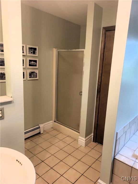 3130 Meadow View Ln, Sennett, NY 13021 - full bath with a baseboard heating unit, a shower stall, tile patterned flooring, and a tub to relax in