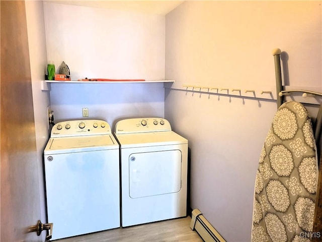 3130 Meadow View Ln, Sennett, NY 13021 - laundry area featuring washer and clothes dryer, wood finished floors, and a baseboard radiator