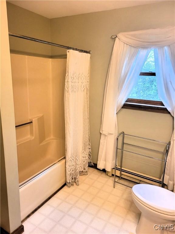 3130 Meadow View Ln, Sennett, NY 13021 - full bath featuring shower / bath combination with curtain, toilet, baseboard heating, and tile patterned floors