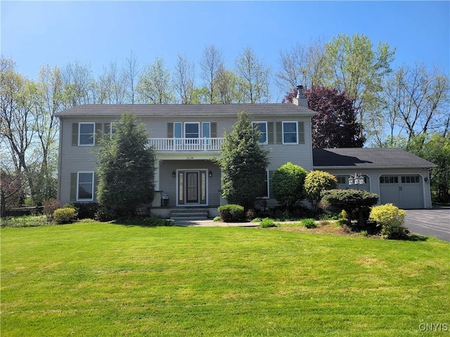 3130 Meadow View Ln, Sennett, NY 13021 - colonial-style house featuring a chimney, a garage, asphalt driveway, and a front yard
