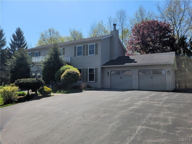3130 Meadow View Ln, Sennett, NY 13021 - colonial home featuring a garage, a chimney, and driveway