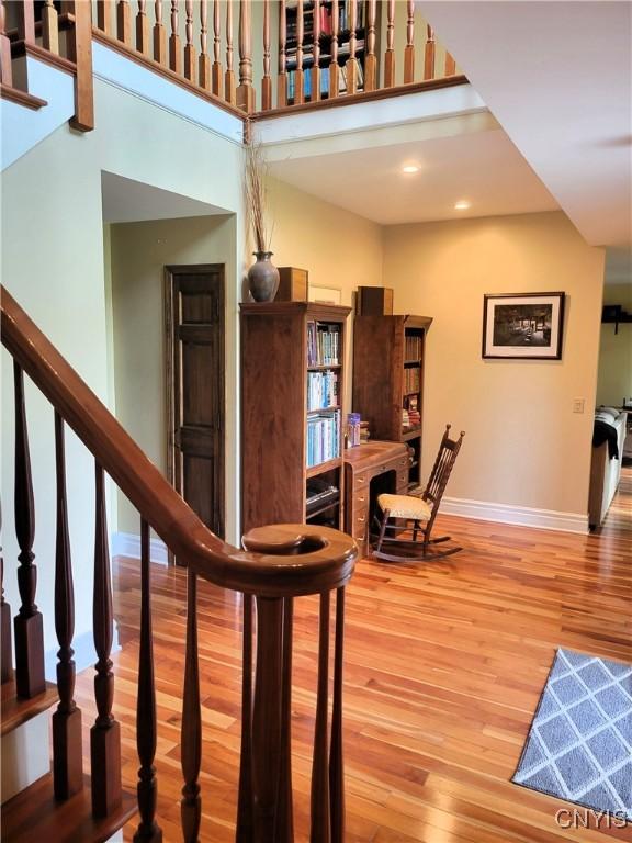3130 Meadow View Ln, Sennett, NY 13021 - staircase with baseboards, wood finished floors, a high ceiling, and recessed lighting