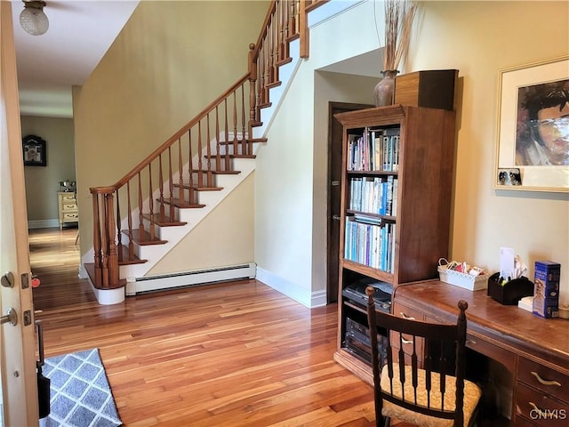 3130 Meadow View Ln, Sennett, NY 13021 - stairway featuring a baseboard heating unit, wood finished floors, and baseboards