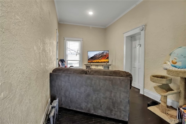 living area featuring crown molding, dark wood-style flooring, a textured wall, and baseboards