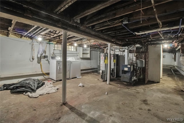 unfinished below grade area featuring washer and dryer, gas water heater, and a heating unit