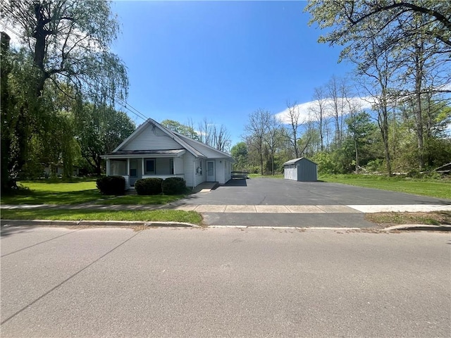 43 Canal St, Big Flats, NY 14814 - view of front of home featuring a shed, an outdoor structure, a front yard, and a garage