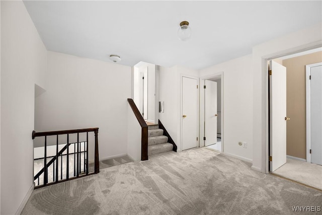 187 Dan Troy Dr, Amherst, NY 14221 - staircase with carpet floors, baseboards, and a baseboard heating unit