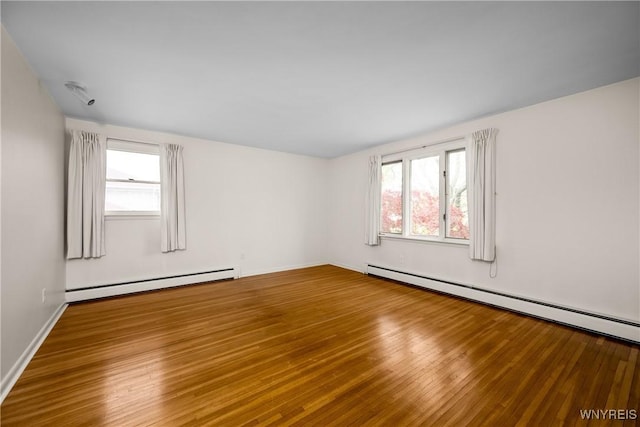 187 Dan Troy Dr, Amherst, NY 14221 - spare room featuring a baseboard heating unit and wood finished floors