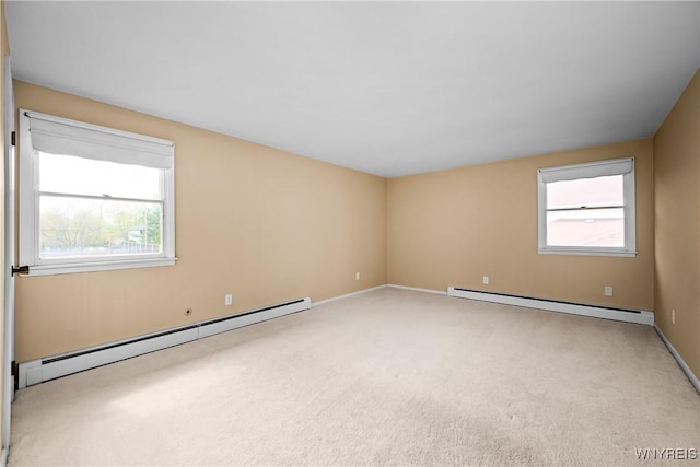 187 Dan Troy Dr, Amherst, NY 14221 - empty room with a baseboard radiator, light colored carpet, and plenty of natural light