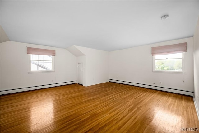 187 Dan Troy Dr, Amherst, NY 14221 - additional living space featuring a baseboard heating unit, baseboard heating, hardwood / wood-style floors, plenty of natural light, and lofted ceiling