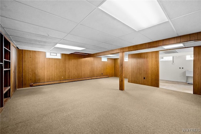 187 Dan Troy Dr, Amherst, NY 14221 - basement featuring wood walls, baseboard heating, carpet flooring, and a paneled ceiling