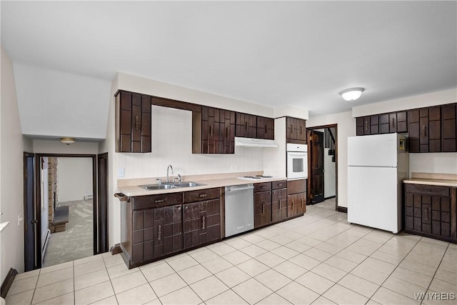 187 Dan Troy Dr, Amherst, NY 14221 - kitchen with white appliances, a sink, light countertops, dark brown cabinetry, and under cabinet range hood