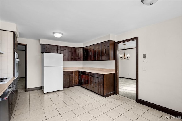 187 Dan Troy Dr, Amherst, NY 14221 - kitchen featuring white appliances, dark brown cabinets, light countertops, baseboards, and a chandelier