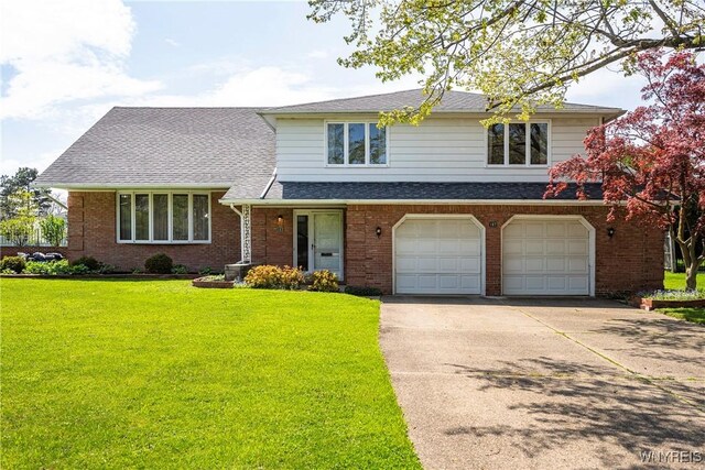 187 Dan Troy Dr, Amherst, NY 14221 - tri-level home featuring driveway, a garage, a front lawn, and brick siding