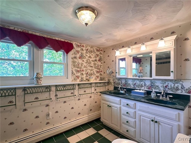 1401 Utica St, Whitestown, NY 13424 - full bath featuring a baseboard radiator, wallpapered walls, plenty of natural light, tile patterned flooring, and double vanity