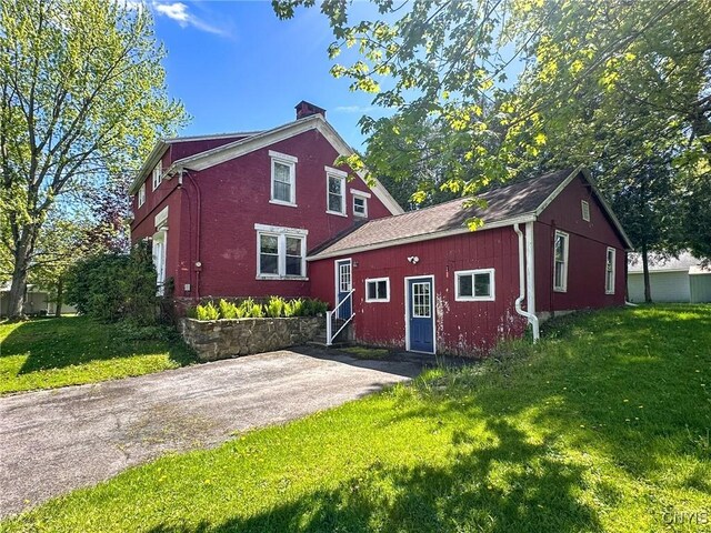 1401 Utica St, Whitestown, NY 13424 - rear view of property featuring a chimney and a lawn