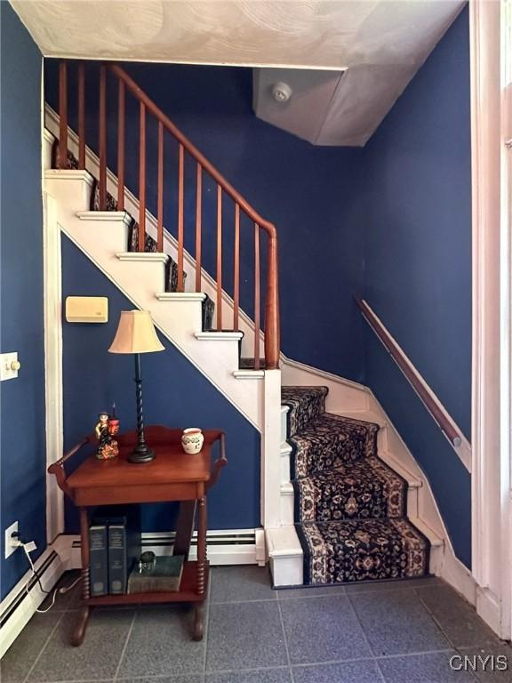 1401 Utica St, Whitestown, NY 13424 - staircase with a baseboard heating unit