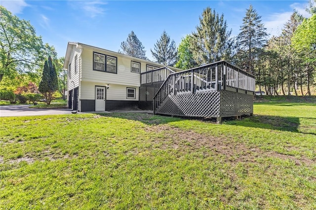 35 Squire Cir, Penfield, NY 14526 - rear view of house featuring stairs, a deck, an attached garage, a yard, and asphalt driveway