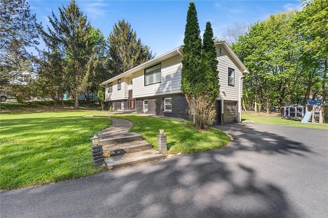 35 Squire Cir, Penfield, NY 14526 - view of front of house with a garage, driveway, a front lawn, and brick siding