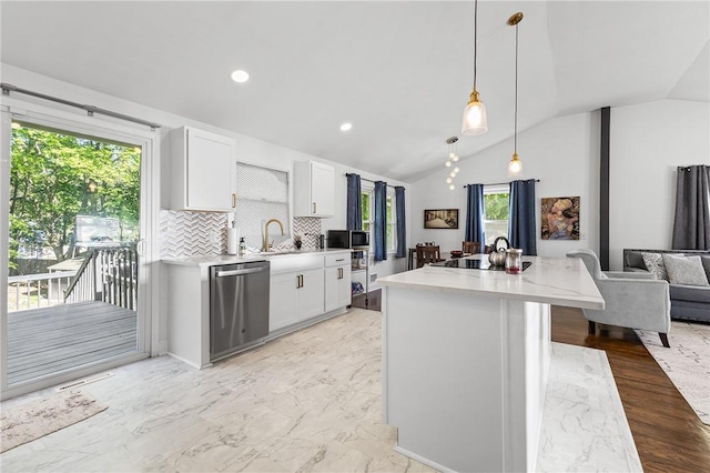 35 Squire Cir, Penfield, NY 14526 - kitchen with appliances with stainless steel finishes, lofted ceiling, white cabinetry, decorative backsplash, and hanging light fixtures